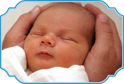 Newborn cradled in an adult's hands