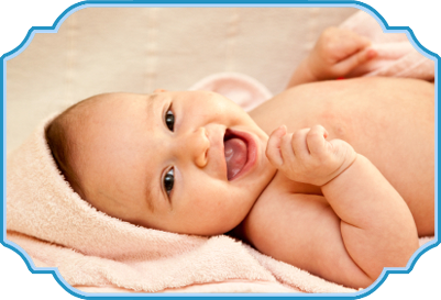 Smiling baby lying on a pink towel